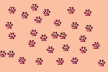Fototapeta na wymiar Pink background with paws. Animal care concept with copy space.