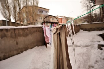 Obraz na płótnie Canvas Ice on clothesline. weather -50 degrees during winter. Erzurum, Turkey travel. Common issue your clothesline may encounter during frosting. snow, Freeze, frostiness, icing, frozen, frosting