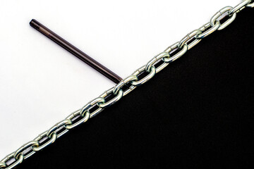 an iron chain divides the plane in half into black and white parts on the white part lies a...
