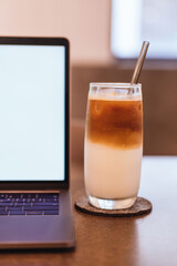 coffee and Laptop on wooden table background. use in Traditional Chinese Alphabet operating system.