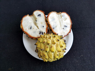 Whole and opened Rollinia deliciosa, is a species of flowering plant in the custard-apple family,...