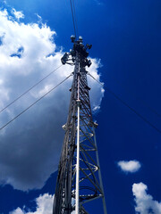 Telecommunication tower on a blue sky background for Internet connection, smartphone, wireless signal. Online service connection concept