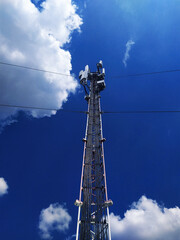 Telecommunication tower on a blue sky background for Internet connection, smartphone, wireless signal. Online service connection concept