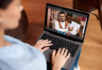 Woman using laptop having video chat with teacher