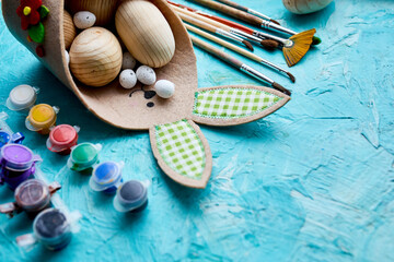 Top view pack of eggs with brush, paint and decorative elements
