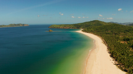 Fototapeta premium Tropical island with sandy beach, aerial view. Nacpan, El Nido, Palawan, Philippine Islands. Seascape with tropical beach and islands. Summer and travel vacation concept