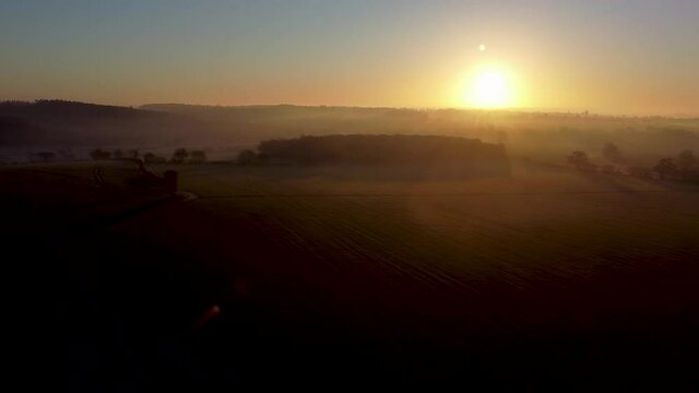 Drone footage of sunrise on a misty morning in a rural part of Suffolk, UK