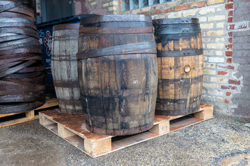 Vintage wooden barrels on a pallet in an industrial setting in urban Chicago