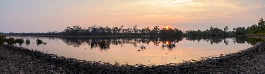 Panoramic view of sunset over the lake in nation park, Thailand.