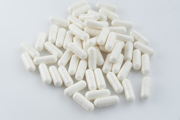 Fototapeta na wymiar white medicine capsules, drugs, on white background, with a blur