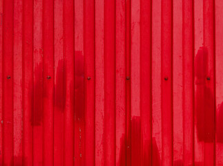Red rippled metal texture with bolts and rivets
