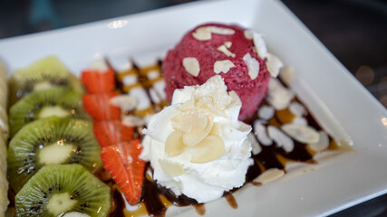 Pancake, kiwi fruit  and strawberry, ice cream and chocolate