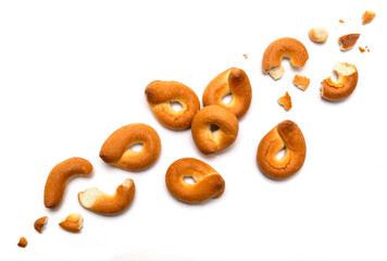 Homemade bagel isolated on white background. Trajectory or flight of broken parts and crumbs top view