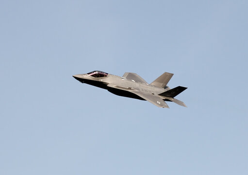 F-22 Raptor fighter jet on low banking pass