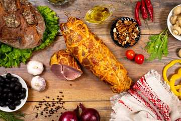 Assortment of cold cuts, a variety of processed cold meat products. On a wooden background