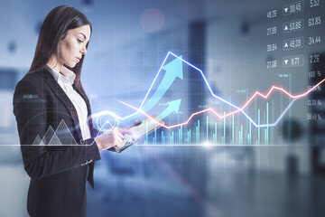 Stock market analysis concept with businesswoman looking at digital tablet display and forex chart projection with trade market graphs and arrows