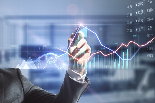 Businessman hand writing on digital screen with financial trade market graphs, diagram and forex chart