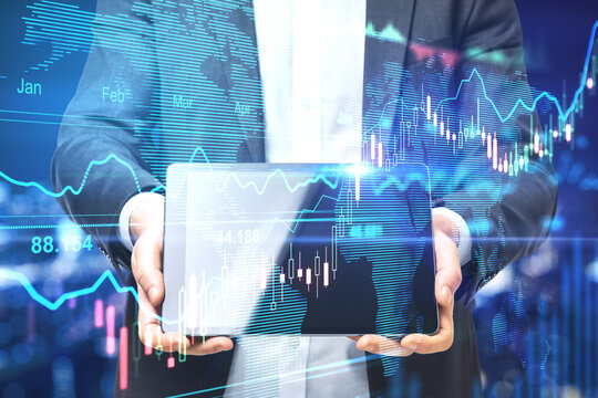 Stock market concept with businessman showing digital tablet display and digital forex chart baord with financial graphs, diagram and candlestick