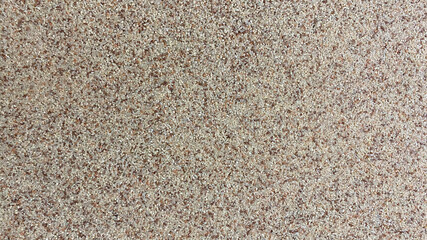 Deocratic wall in the interior made of small brown stones. Background, texture