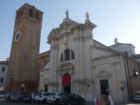 Chioggia, Church of Sant'Andrea Apostole with the facade decorated in Istrian stone and the Bell Tower with the ancient clock