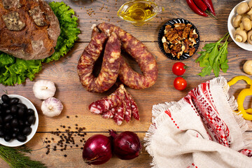 Assortment of cold cuts, a variety of processed cold meat products. On a wooden background