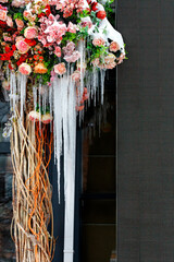A bouquet of snow-covered flowers with ice icicles on the terrace.