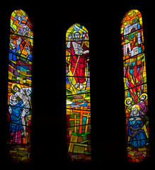 Triptych of stained-glass windows in the old church