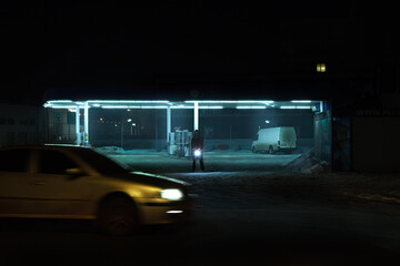 Obraz na płótnie Canvas Lonely girl at the gas station