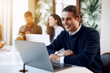 Focused young businessman in eyewear wearing holding video call with clients on laptop. Concentrated millennial man in glasses giving online educational class lecture, consulting customer.