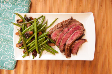 seared flank steak with green beans and mushrooms - Powered by Adobe