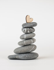 Pyramid of sea pebbles on white background. Life balance and harmony concept
