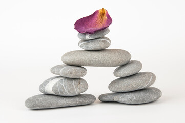 Obraz na płótnie Canvas Pyramid of sea pebbles on white background. Life balance and harmony concept