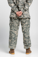 Fototapeta na wymiar Back view of woman in military uniform on grey background