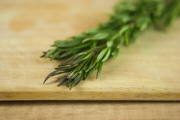 A bunch of fresh rosemary on the table.