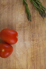 tomatoes with rosemary on wood table
