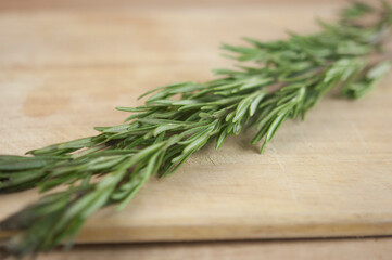 A bunch of fresh rosemary on the table.