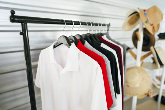 Close up of simple polo shirts on clothes rack