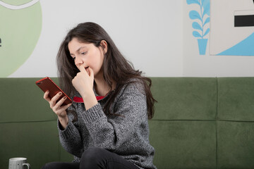 Young girl looking at message from close friend and replying