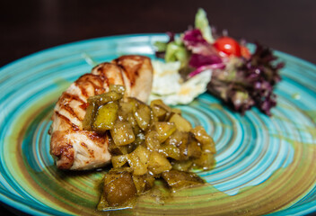 Grilled pork meat with pound cucumber and salad .