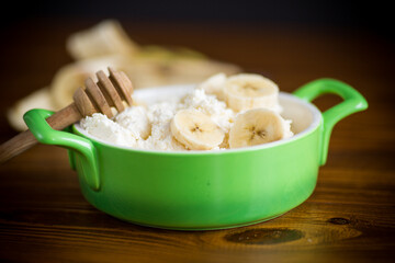 homemade cottage cheese in a bowl with bananas and honey