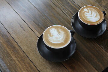 Coffee cup of cappuccino with latte art on wooden and Copy space