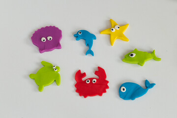 Making sea animals with play dough.Colorful turtle, fish, whale, crab, starfish, shark, seashell. 