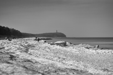 winter seascape - beach, sand, snow, people, walkers, lighthouse, coast, seaside, relaxation, winter, seasons, sandy beach, icy shore