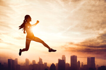 Woman wear sportswear while jumps with cityscape