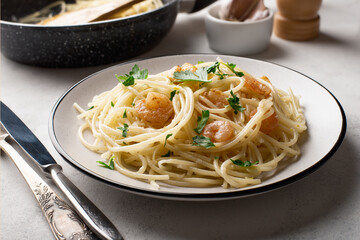 Spaghetti shrimp scampi with parsley in a plate close-up