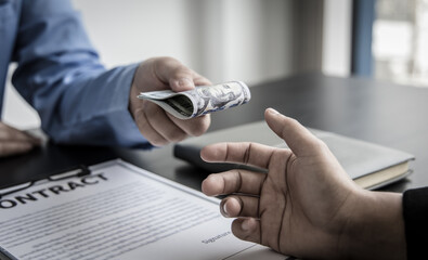 Fototapeta premium Opposition to wrongdoing and social injustice, Businessmen give bribes to employees to sign approvals through illegal projects, Fraud and corruption Or something illegal.