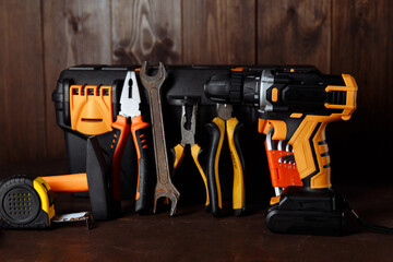 Set of different tools for work on wood background.