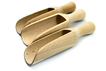 Small wooden scoops for spices isolated on white background