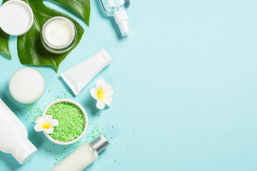 Natural cosmetic products, spa background at blue. Cream, mask, lotion and sea salt. Top view image with copy space.