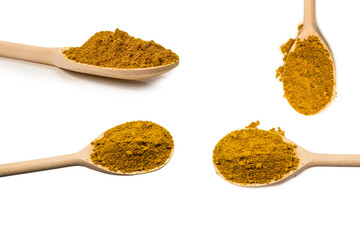 Curry in wooden spoon isolated on white.